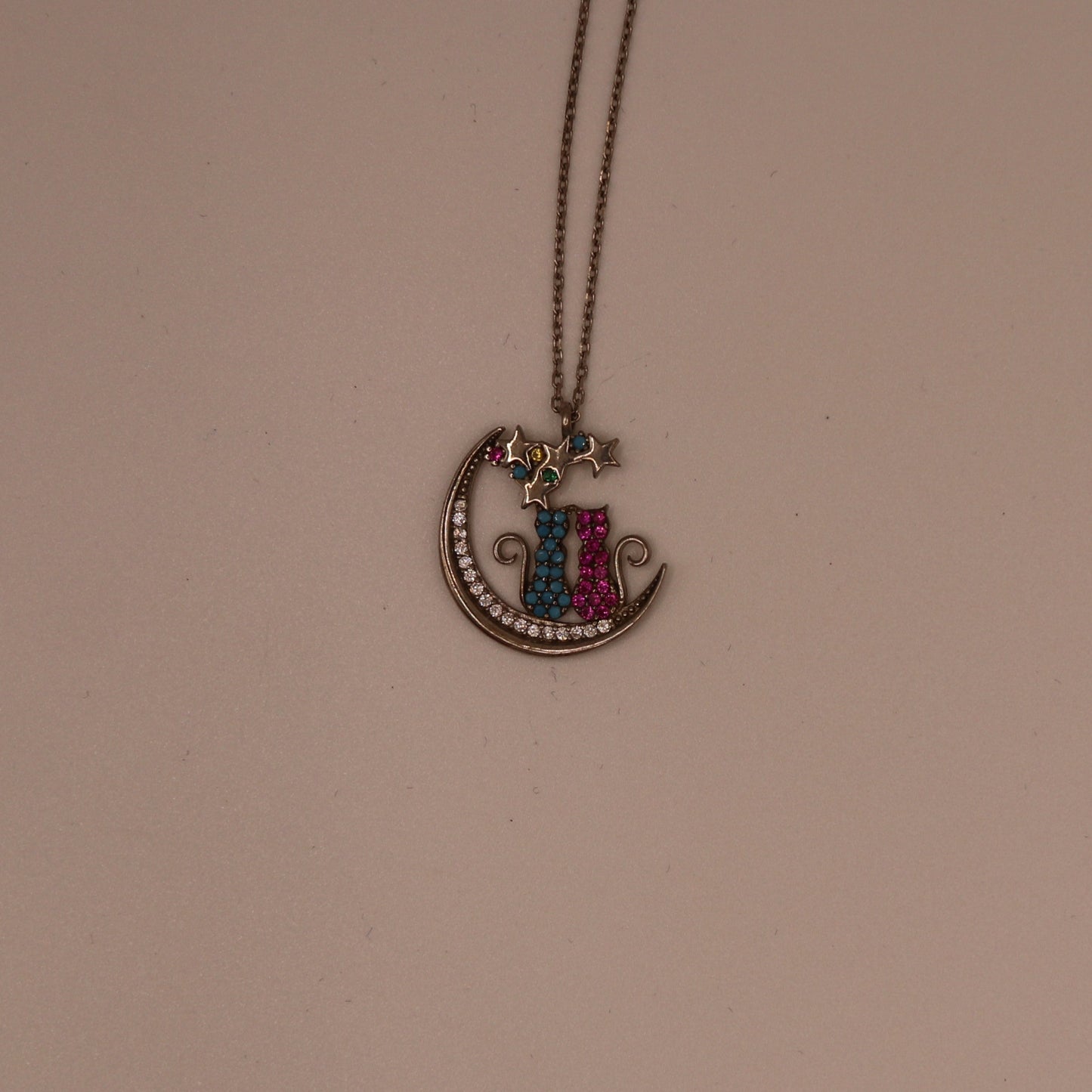 Necklace with a colorful pendant on a beige background