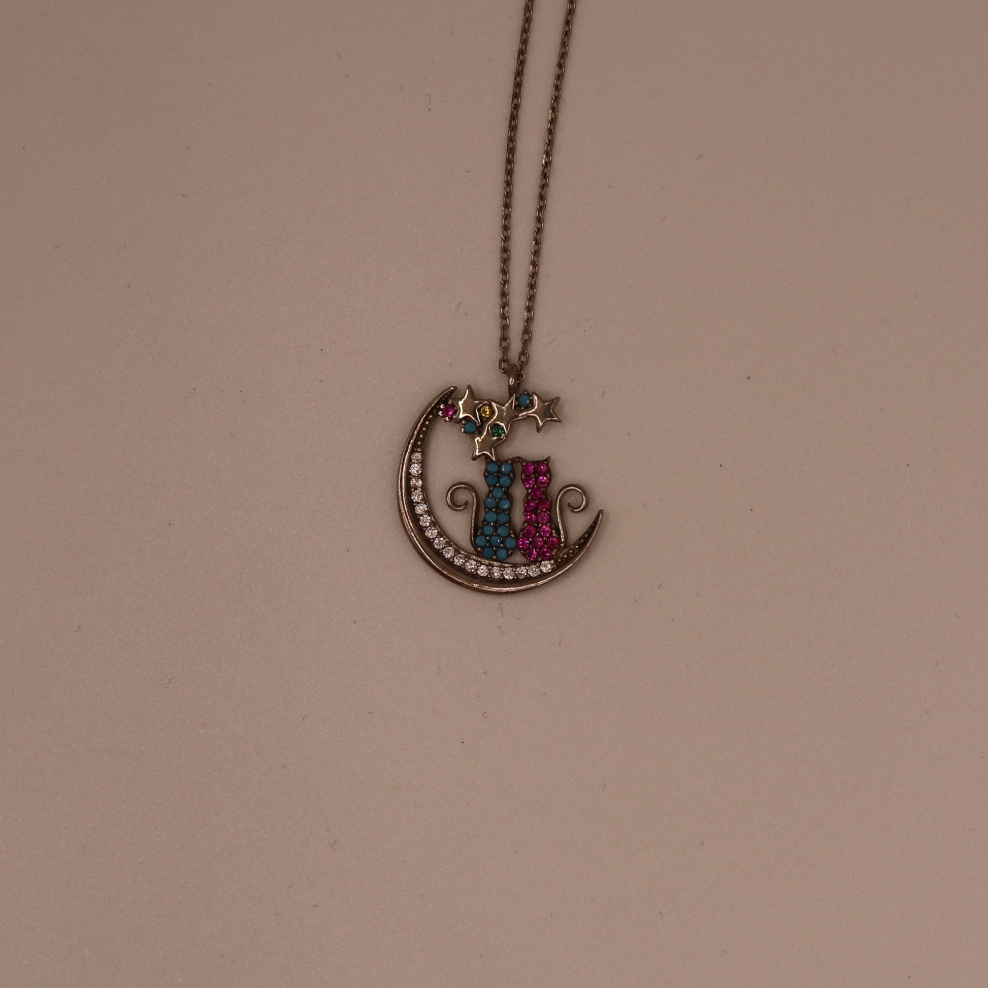 Necklace with a colorful pendant on a beige background